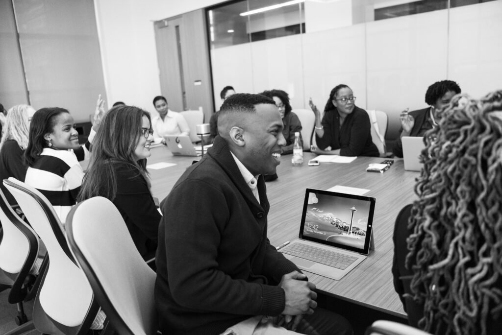 Group of People Sitting in Conference Table Laughing, MICE Tourism, MICE Magazine